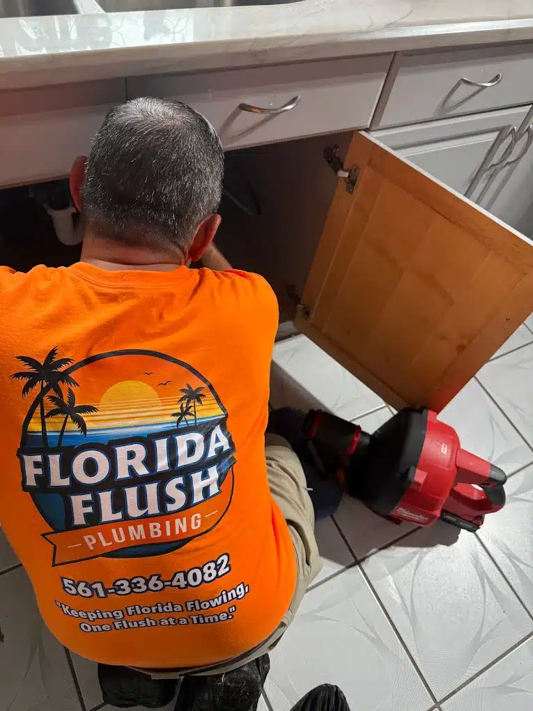 Plumber wearing orange Florida Flush t-shirt doing cast iron repipping