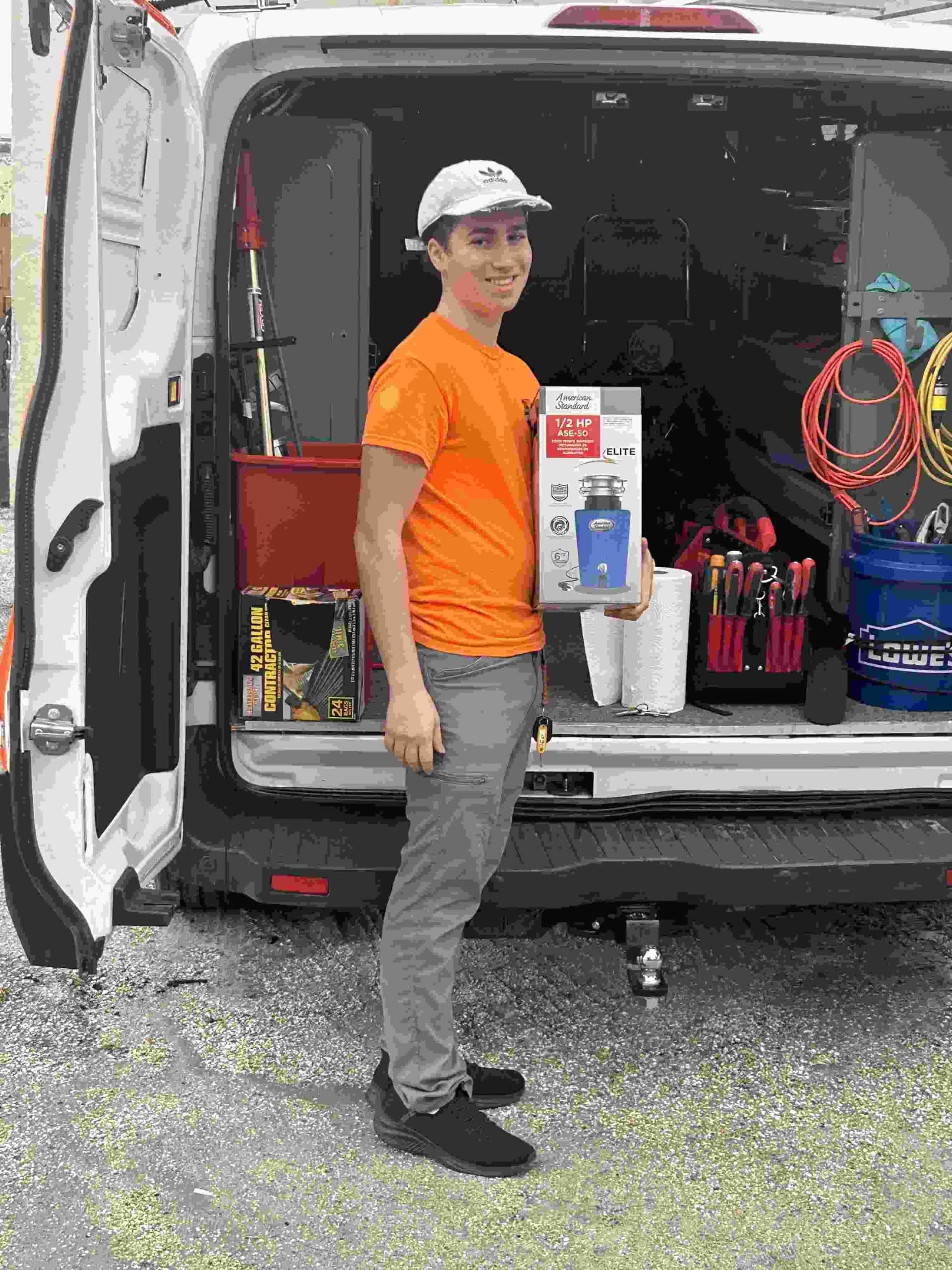 Plumber standing with his van